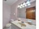 The bathroom features a vintage sink with a large mirror, and a combo tub/shower at 1123 Enchanted Dr, Lakeland, FL 33801