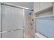 Close-up of a shower with sliding glass doors and a wall-mounted handheld shower head at 1123 Enchanted Dr, Lakeland, FL 33801