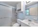 Cozy bathroom featuring a shower with glass doors and a single sink vanity with storage at 1123 Enchanted Dr, Lakeland, FL 33801