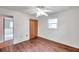 Inviting bedroom with sleek wood flooring, a ceiling fan, and a closet at 1123 Enchanted Dr, Lakeland, FL 33801