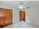 Bright bedroom with double closet and ceiling fan, offering a calm, neutral space at 1123 Enchanted Dr, Lakeland, FL 33801