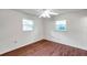 Bright bedroom with two windows and attractive flooring, featuring a ceiling fan with lights at 1123 Enchanted Dr, Lakeland, FL 33801