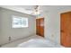 Neutral bedroom with closet and window, featuring a ceiling fan and comfortable carpeting at 1123 Enchanted Dr, Lakeland, FL 33801