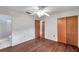 Comfortable bedroom with hardwood floors, ceiling fan, and access to the bathroom at 1123 Enchanted Dr, Lakeland, FL 33801