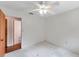 This bedroom has neutral walls, a ceiling fan, and wood-look floors outside the entrance at 1123 Enchanted Dr, Lakeland, FL 33801