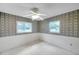 Comfortable bedroom featuring bright windows and vintage patterned wallpaper at 1123 Enchanted Dr, Lakeland, FL 33801