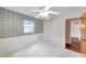 Bedroom with a window and doorway; features vintage-style wallpaper and painted trim at 1123 Enchanted Dr, Lakeland, FL 33801