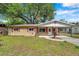 Charming single-story brick home with red shutters and carport at 1123 Enchanted Dr, Lakeland, FL 33801
