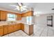 Functional kitchen with tile floors, white appliances, and ample countertop space at 1123 Enchanted Dr, Lakeland, FL 33801