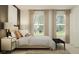 Bright bedroom featuring neutral tones, three windows, and modern nightstand at 1393 Acorn Meadow Loop, Eustis, FL 32726