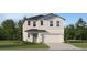 Two-story home showcasing a neutral color palette, attached two-car garage, and manicured lawn at 1393 Acorn Meadow Loop, Eustis, FL 32726
