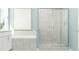 Elegant bathroom with tiled shower, soaking tub, and a bright, modern aesthetic at 2155 Rider Rain Ln, Apopka, FL 32703