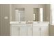 Modern bathroom features double sinks, white cabinetry, quartz countertop, and ample storage space at 2155 Rider Rain Ln, Apopka, FL 32703