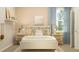 Serene bedroom with a comfortable bed, soft lighting, neutral decor, and a calming ambiance, great for relaxation at 2155 Rider Rain Ln, Apopka, FL 32703
