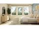 Relaxing bedroom with natural light, cozy seating, modern dresser, and a comfortable bed at 2155 Rider Rain Ln, Apopka, FL 32703