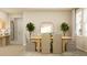 Elegant dining room featuring a wooden table with seating for four, stylish decor, and a bright, inviting atmosphere at 2155 Rider Rain Ln, Apopka, FL 32703