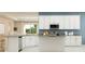Well-appointed kitchen featuring white cabinets, stainless steel appliances, and a functional island with ample counter space at 2155 Rider Rain Ln, Apopka, FL 32703