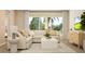 Cozy living room with a comfortable sectional sofa, neutral tones, large windows, and views of the backyard at 2155 Rider Rain Ln, Apopka, FL 32703