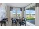 Cozy dining area features a modern table setting and picturesque views of the lake at 2275 Rider Rain Ln, Apopka, FL 32703