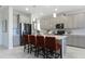 Modern kitchen featuring an island with bar seating, stainless steel appliances, and stylish gray cabinetry at 2275 Rider Rain Ln, Apopka, FL 32703