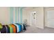 Colorful bedroom featuring blue striped accent wall, playful bed, and closet, a joyful space at 2301 White Buffalo St, Apopka, FL 32703