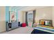 Vibrant bedroom with stylish dresser, cozy beanbag, and colorful bedding, a playful retreat at 2301 White Buffalo St, Apopka, FL 32703