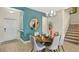 Dining area showcases decoratively set table and chairs and modern lighting at 2301 White Buffalo St, Apopka, FL 32703