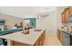 Open kitchen featuring an eat-in island, stainless appliances and hardwood floors at 2301 White Buffalo St, Apopka, FL 32703