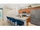 Eat-in kitchen boasts an island with stainless steel sink and seating at 2301 White Buffalo St, Apopka, FL 32703