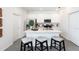 Modern kitchen features white cabinetry, stainless steel appliances, and an island with seating at 2329 White Buffalo St, Apopka, FL 32703