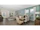 Airy living room and dining space with neutral tones, large windows, and elegant decor at 2853 Haze Rd, Clermont, FL 34714