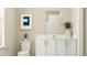 Stylish bathroom with a white vanity, framed mirror, and modern fixtures at 2899 Transformation Way, Clermont, FL 34714