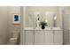 Modern bathroom featuring dual sinks, white cabinets, framed mirrors and clean design at 2899 Transformation Way, Clermont, FL 34714