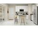 Bright kitchen featuring stainless steel appliances, white cabinets, gray countertop and a center island with seating at 2899 Transformation Way, Clermont, FL 34714