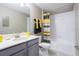 Well-lit bathroom featuring modern fixtures, a shower with a stylish curtain, and sleek vanity at 3001 Namaste Dr, Clermont, FL 34714