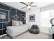 Modern bedroom with unique wall art, comfortable daybed, and stylish decor at 3001 Namaste Dr, Clermont, FL 34714