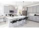 Modern kitchen with gray cabinets, stainless appliances, a pantry and a large island with bar seating at 3001 Namaste Dr, Clermont, FL 34714