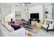 Well-lit living room with a large TV, stylish decor, and comfortable seating arrangements at 3001 Namaste Dr, Clermont, FL 34714