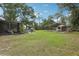 Expansive backyard featuring a screened patio, above ground pool, and a covered structure for versatile outdoor living at 3807 Timberlake N Rd, Lakeland, FL 33810