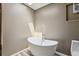 Bright bathroom featuring a modern soaking tub, skylight, wood-look floors, and neutral wall tones at 3807 Timberlake N Rd, Lakeland, FL 33810