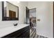 Bathroom featuring a single vanity, shower-tub combo with wood-look tile surround, and a window at 3807 Timberlake N Rd, Lakeland, FL 33810