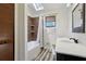 Bathroom featuring a single vanity, shower-tub combo with wood-look tile surround, and a window at 3807 Timberlake N Rd, Lakeland, FL 33810