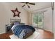 Staged bedroom featuring a ceiling fan and sliding glass doors providing ample natural light at 3807 Timberlake N Rd, Lakeland, FL 33810