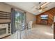 Tile-floored dining area with a TV, a large window, and a fireplace at 3807 Timberlake N Rd, Lakeland, FL 33810