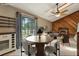 Open-concept dining room with modern furnishings, a view to the living room with a fireplace at 3807 Timberlake N Rd, Lakeland, FL 33810