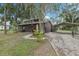 Charming home featuring a gravel driveway, carport, and nicely landscaped front yard at 3807 Timberlake N Rd, Lakeland, FL 33810