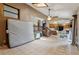 Open-concept living area with tile floors, modern staircase, and an adjacent kitchen at 3807 Timberlake N Rd, Lakeland, FL 33810