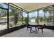 Screened patio with a table and chairs provides a relaxing view of the landscaped backyard at 3807 Timberlake N Rd, Lakeland, FL 33810