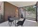 Screened patio with seating offers an inviting space to enjoy the outdoors, with a door and backyard views at 3807 Timberlake N Rd, Lakeland, FL 33810
