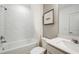 Bathroom featuring a shower over tub with white subway tile, modern fixtures, and a neutral color palette at 8303 Sw 54Th Loop, Ocala, FL 34481